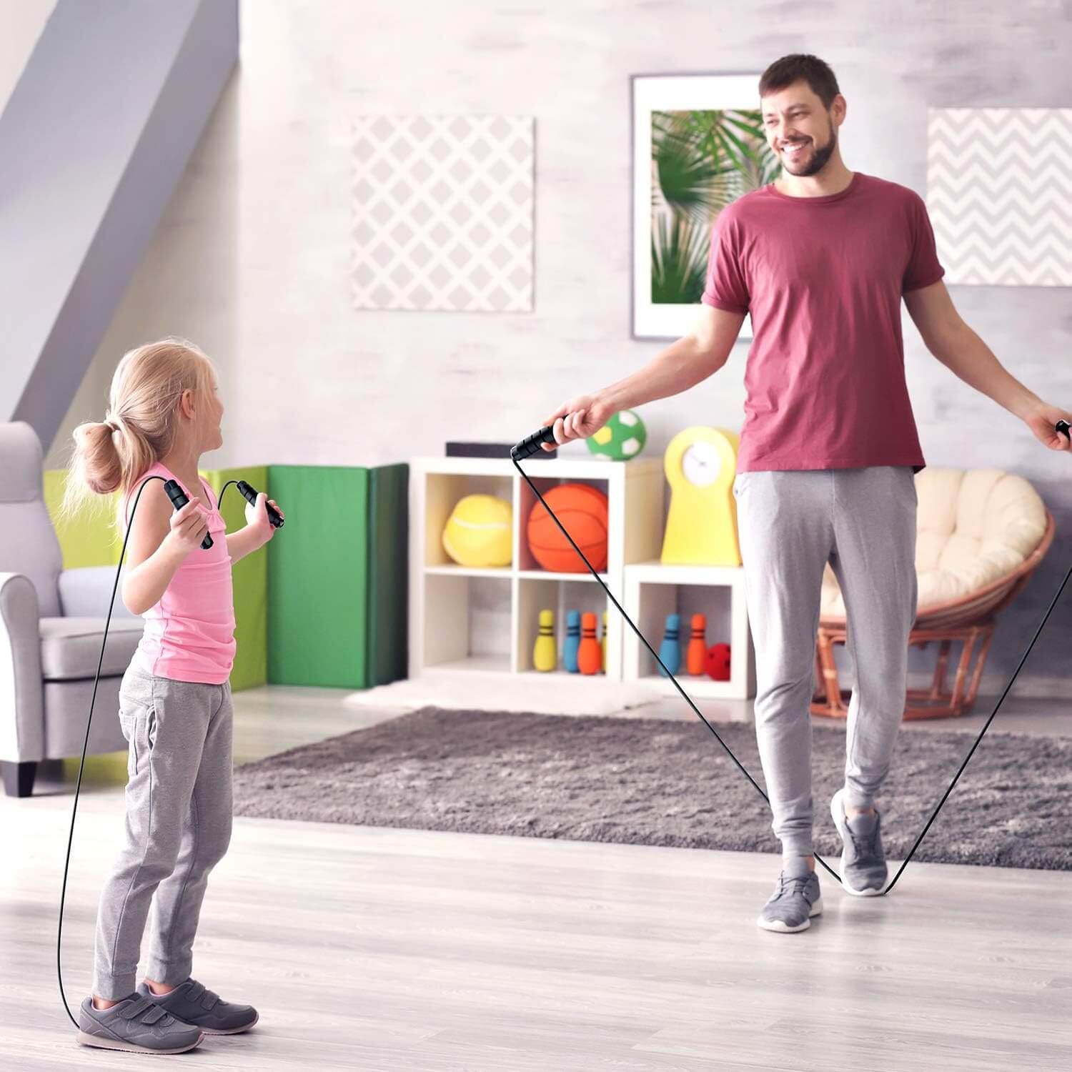 Father and daughter enjoying a workout with the Herbionyx Speed Jump Rope in a bright indoor space.
