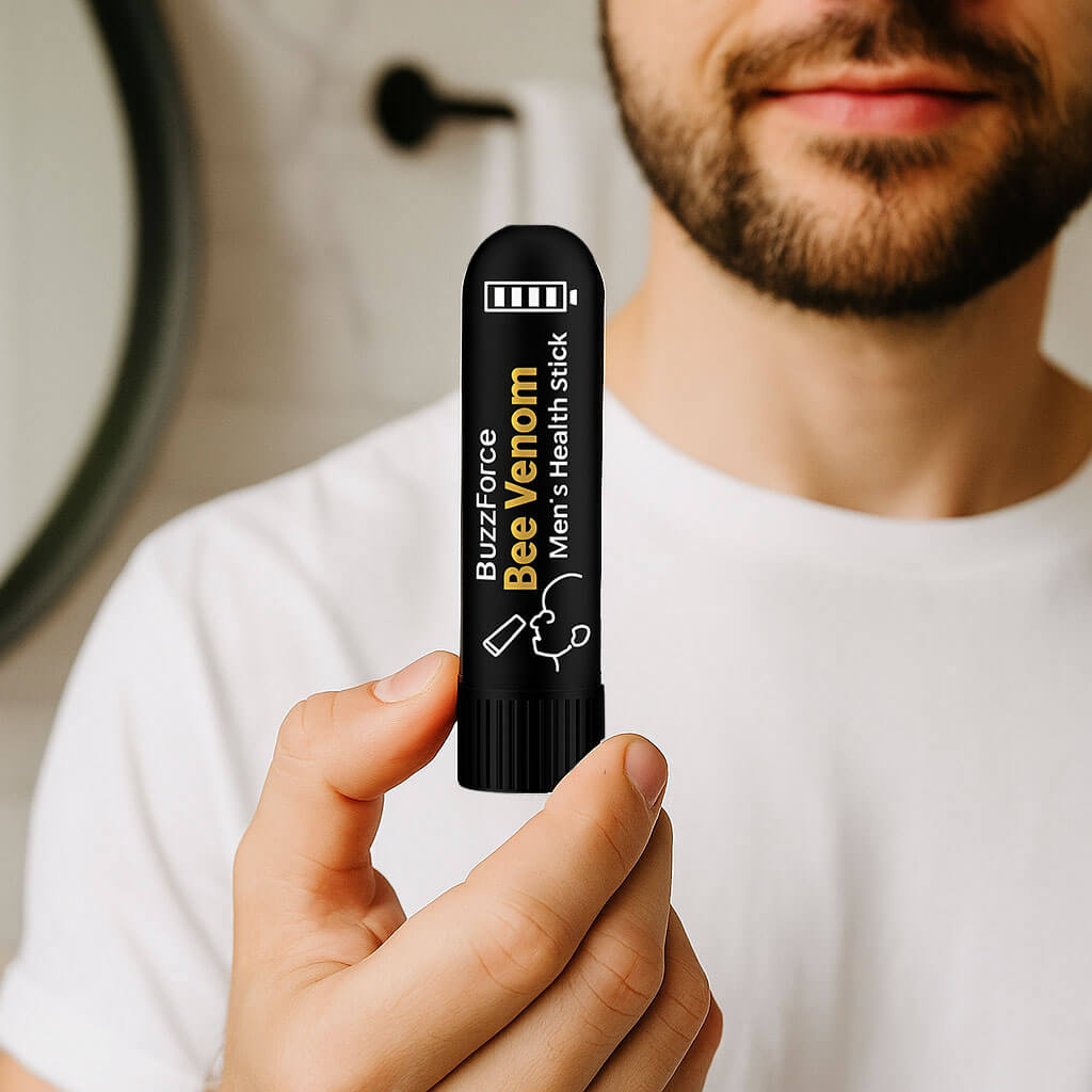 BuzzForce Bee Venom Men's Health Stick held by a man in a bathroom, promoting prostate comfort and energy.