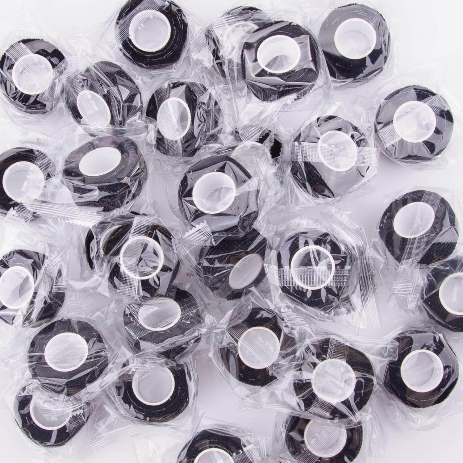 Collection of individually wrapped black adhesive strips for skin care, designed for comfort and easy application.