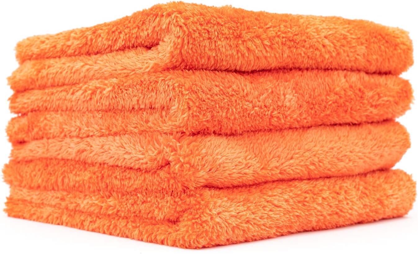 Stack of four vibrant orange UltraSoft microfiber towels designed for polishing and detailing surfaces.